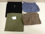 three pairs of men ' s shorts and a t - shirt sitting on a table