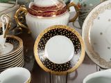 many plates and cups and saucers on the table