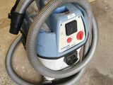a vacuum that is sitting on the floor in the garage
