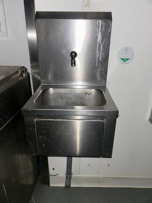 a stainless steel sink in a public restroom