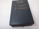 an old book sitting on top of a table next to a white table