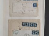 two old envelopes with stamps on them sitting on a table