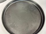 a pan on a table with a knife and a knife rest on it