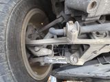 a close up of a car ' s front wheel and axle