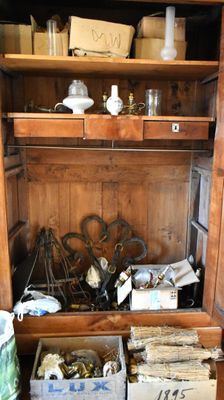 a wooden cabinet with a bunch of items inside of it