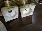 two candles that are sitting on a wooden table