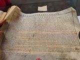 someone is holding a large piece of paper with writing on it