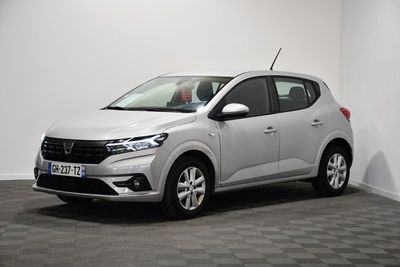 a white car is parked in a room with a checkered floor