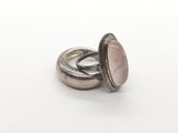 silver ring with a pink stone in the center