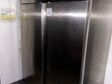 a large stainless steel refrigerator in the corner of a room