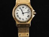an image of a gold wrist watch with roman numerals on it