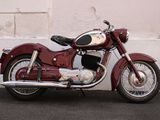 a red motorcycle parked on the side of the road
