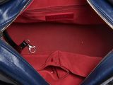 a blue purse with a red shirt inside of it