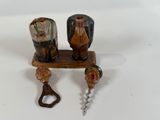 a bottle opener and a corkscrew on a table