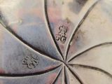 a close up of a silver vase on a table