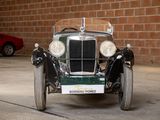 a vintage car parked in a garage next to a brick wall