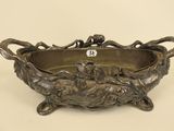 an ornate bronze bowl with handles and handles on a white background