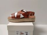 a close up of a pair of sandals on top of a box