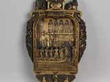 une image représentant une horloge en or sur laquelle figurent un homme et une femme
