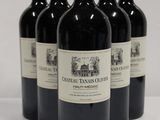 four bottles of red wine are lined up on a white surface