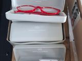 several boxes of glasses are stacked on top of each other
