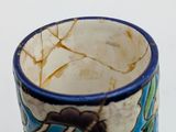 a close up of a cup with a design on it