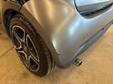a close up of a car ' s front bumper and tire