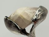 silver ring with a white stone in the middle and a spoon in the middle