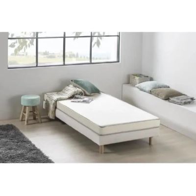 an image of a bed with a mattress and pillows in a room