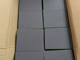 the box is full of gray foam blocks in a cardboard box
