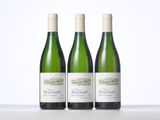 three bottles of wine sitting on top of a table next to each other