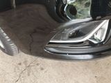a close up of a car ' s headlight and front bumper