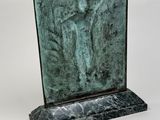 a statue of a man with a cross on a marble base