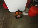 a fire extinguisher sitting on the floor next to a fire hydrant