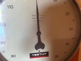 a clock that is sitting on a shelf in a room