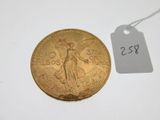a close up of a gold coin with a price tag on it