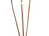 three wooden sticks are lined up on a white surface