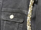 a close up of a man ' s jacket with a gold chain