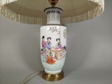a lamp that is sitting on a table with a lamp shade on it