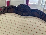 a bed that has a wooden head board on it