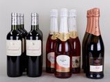 several bottles of wine are lined up on a table