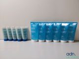 a group of five tubes of lotion sitting on top of a table