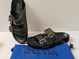 pair of black leather sandals with gold buckles and a blue cloth