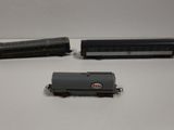 two toy trains sitting on top of a table next to each other
