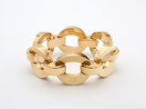 a close up of a gold ring on a white surface