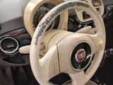 a steering wheel and dashboard of a small car