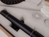 a black shower head in a box on a table