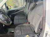 the interior of a white van with the door open and the seats down