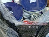 many buckets of paint sitting in a plastic bag