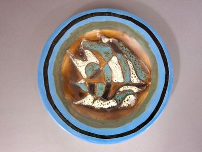 une assiette bleue et blanche ornée d'un motif de poisson